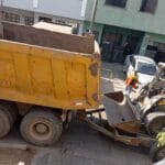 Carga de desmonte en volquete amarillo con minicargador para retiro de residuos de construcción. Eliminación de desmonte